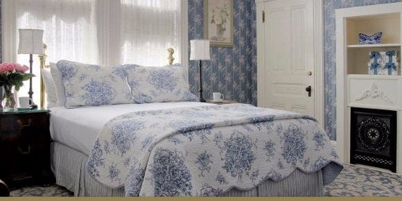 Ellis Room bed view with nightstand and lamps