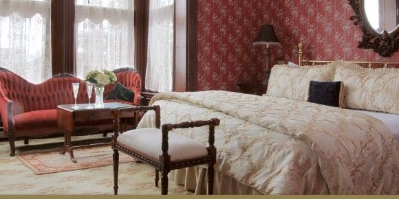 Victorian Parlor sitting area and bed in victorian decor